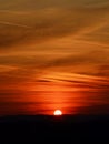 Orange sunset reflects on strange clouds