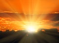 Orange sunset with sunbeams Royalty Free Stock Photo