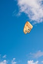 Orange surfing kite on blue cloudy sky background on the island of Barbados Royalty Free Stock Photo