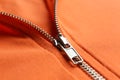 Orange sweatshirt with zipper as background, closeup view Royalty Free Stock Photo