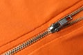 Orange sweatshirt with zipper as background, closeup view Royalty Free Stock Photo