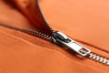 Orange sweatshirt with zipper as background, closeup view Royalty Free Stock Photo