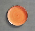 Orange Swirl Melamine Plate with dark gray background