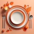 an orange table setting with a white plate fork knife and spoon Royalty Free Stock Photo