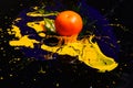 Orange or tangerine covered with paints. Nutrition and food art