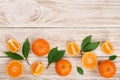 Orange or tangerine with leaves on white wooden background. Flat lay, top view. Fruit composition