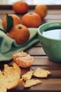 Orange tangerine and mandarin slices, green cup of tea Royalty Free Stock Photo