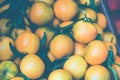 Orange tangerines mandarin in a box ourdoors market. Toned image.