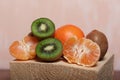 Orange tangerines. One without a peel. Kiwi fruit cut in half. Juicy green flesh is visible. Close-up shot Royalty Free Stock Photo