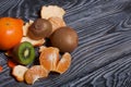 Orange tangerines. One without a peel. Kiwi fruit cut in half. Juicy green flesh is visible. Close-up shot Royalty Free Stock Photo