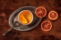 Orange tea with fresh and dried oranges on a vintage tray on a wooden table Royalty Free Stock Photo