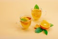 Orange tea in glass cups with ripe fruits. Refreshment seasonal drink, conceptual background Royalty Free Stock Photo