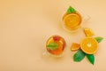 Orange tea in glass cups with ripe fruits. Refreshment seasonal drink, conceptual background Royalty Free Stock Photo