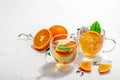 Orange tea in glass cups with ripe fruits. Refreshment seasonal drink, conceptual background Royalty Free Stock Photo