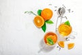Orange tea in glass cups with ripe fruits. Refreshment seasonal drink, conceptual background Royalty Free Stock Photo
