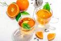 Orange tea in glass cups with ripe fruits. Refreshment seasonal drink, conceptual background Royalty Free Stock Photo