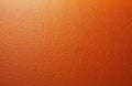 Orange textured background. Close up of artificial leather surface. Decorative PVC material with an embossed pattern. The Royalty Free Stock Photo
