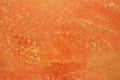 Wall covered with paint and putty in close-up. Bright orange background