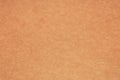 Orange textured paper background, light brown pasteboard surface