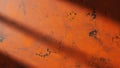 Orange abstract grunge wall texture background with dark shadow lines creating a dynamic distressed pattern, showing weathered Royalty Free Stock Photo