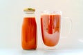 Orange Thai milk tea put in a bottle and put a glass with ice on the back with a white background Royalty Free Stock Photo