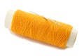 Orange thread bobbin with needle Royalty Free Stock Photo