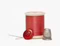 Orange thread, button, thimble, and needle Royalty Free Stock Photo