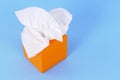 Orange box kleenex style tissues, blue background, copy space Royalty Free Stock Photo