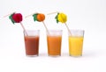 Orange, tomato and kiwi juices - in glasses with straws Royalty Free Stock Photo