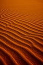 Orange toned sand background with a wavy pattern Royalty Free Stock Photo