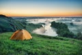 Orange tourist tent on hillside Royalty Free Stock Photo