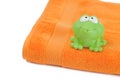 Orange towel and toy frog Royalty Free Stock Photo