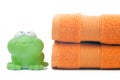 Orange towels and toy frog Royalty Free Stock Photo
