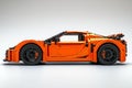 Orange toy car model made of bricks. Royalty Free Stock Photo