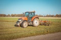 Orange Tractor with Blue Sky in Drenthe, the Netherlands