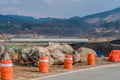 Orange traffic barrels on roadside