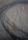 Orange traffic cone and skid marks Royalty Free Stock Photo