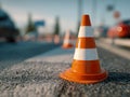 Orange traffic cones lined up on a paved road surface marking a construction or maintenance zone during daytime with blurred Royalty Free Stock Photo