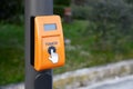 Orange traffic light push button on pillar outdoors Royalty Free Stock Photo