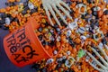 Halloween candy spilling out of orange trick or treat bucket