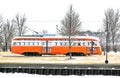Orange Trolley Moving Through Town