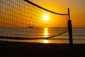 Tropical sunset with volleyball net silhouette