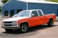 Orange truck american car parked