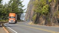 Orange truck travelling southbound through curves on Pacific Coast Highway in Oregon