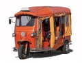 An orange tuktuk