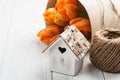 Orange tulips, wooden heart shape bird house and twine Royalty Free Stock Photo
