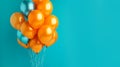 Orange and turquoise festive ballons on a turquoise background. Banner, copy space.