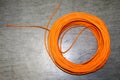 Orange twisted pair cable isolated on floor of data center