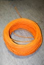 Orange twisted pair cable isolated on floor of data center