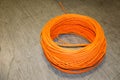 Orange twisted pair cable isolated on floor of data center